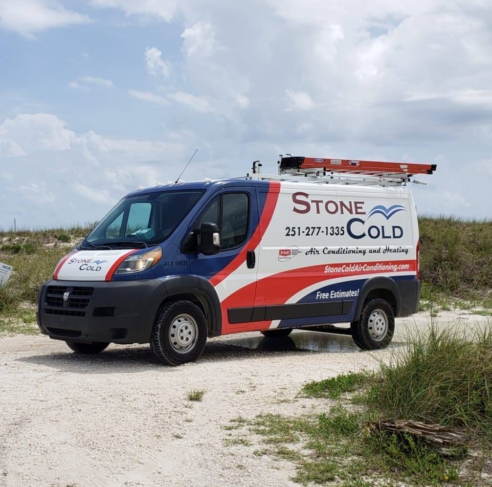 Stone Cold service van at the beach, displaying the company's red and blue branding